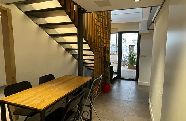 Dining area and staircase at Panda Coworking