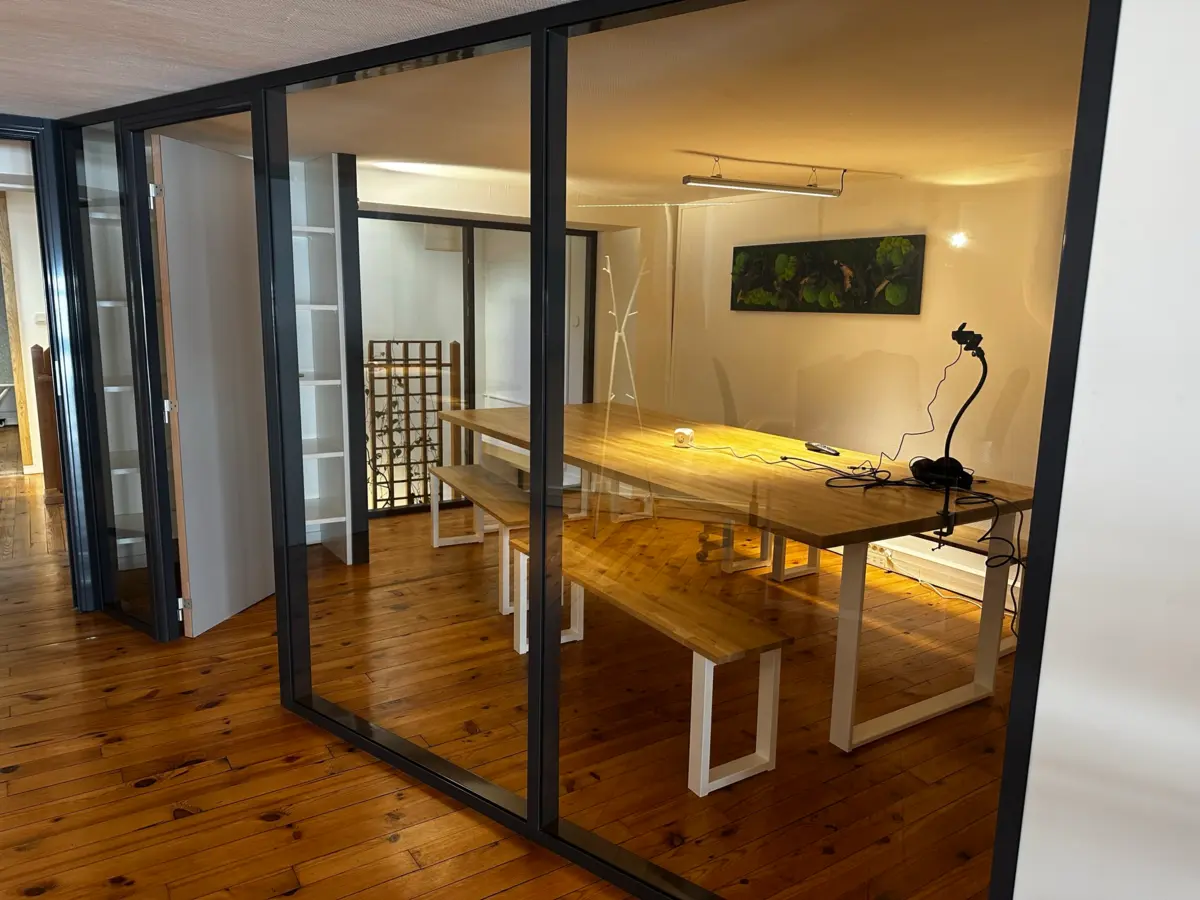 Glass-walled meeting room at Panda Coworking