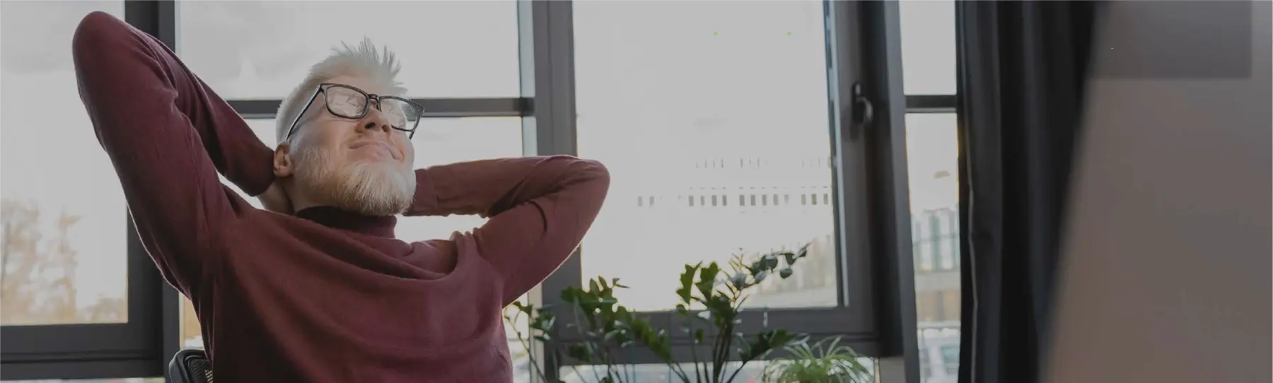 A relaxed coworker by a window